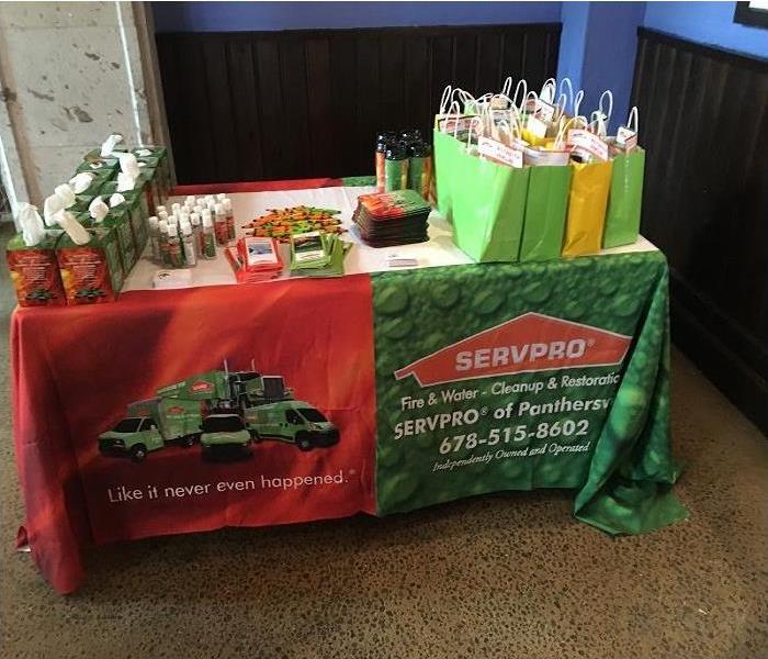 The company’s souvenirs and brochures are displayed on the sponsored table.